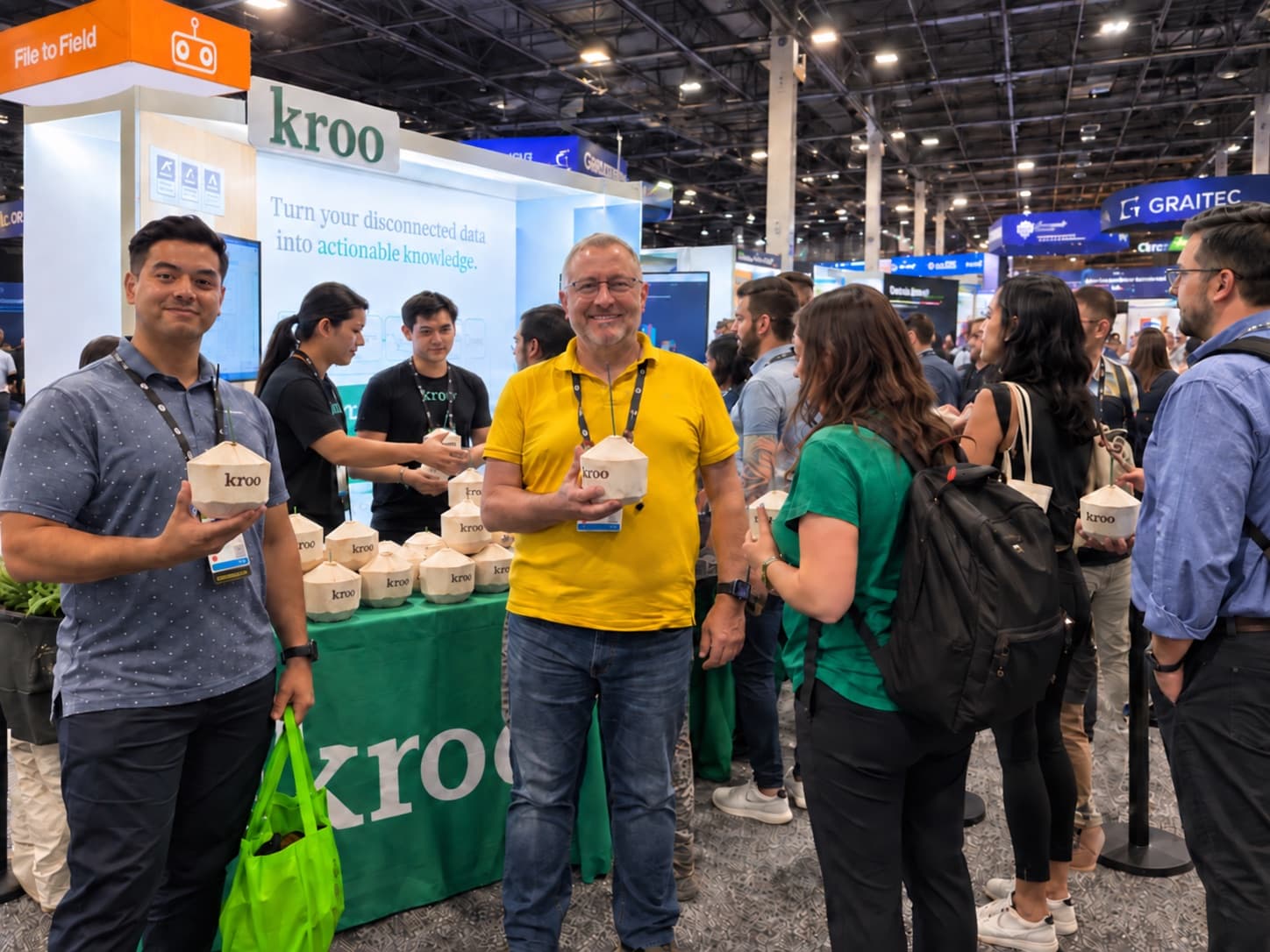 Booth staff handing branded coconuts to attendees on a conference floor